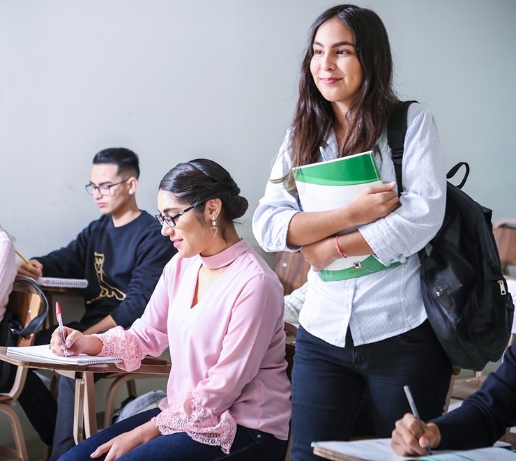 A student is standing in the classroom
